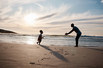 Image showing Child run into father arms, beach and family with games, love and travel, freedom and fun together outdoor. Happy people, freedom and adventure, man and girl bond with tropical holiday and silhouette