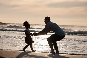 Image showing Sunset, beach and silhouette of father with girl child in nature, bond and playing, freedom and enjoying summer vacation. Ocean, shadow and kid hug parent at sea with love, care and embrace in Bali