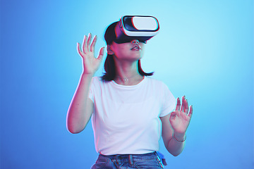 Image showing Woman, VR and glasses for futuristic metaverse, 3d games and gen z education or digital e learning. Young person or student in virtual reality, high tech with vision, neon and blue,studio background