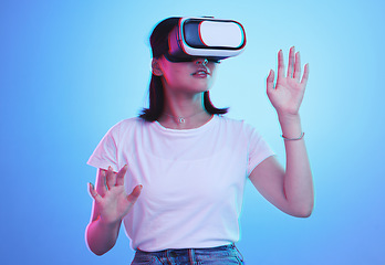 Image showing Glasses, virtual reality and woman in futuristic metaverse, 3d games in education or digital e learning. Young person or student in VR, high technology or vision with neon and blue, studio background