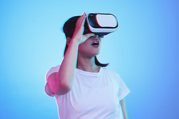 Image showing Woman, VR and vision with wow for futuristic experience, 3d games and gen z education or digital e learning. Student with surprise for virtual reality, high tech and glasses on blue studio background