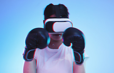 Image showing AI, metaverse and a boxer woman gaming on a blue background in studio for fitness or exercise. Virtual reality, sports and training with a young female player boxing an online fantasy game for health