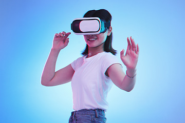 Image showing Metaverse gaming, headset and woman on blue background for virtual reality creativity. Smile, touching and a girl with digital glasses for a cyber game, experience or future technology on a backdrop