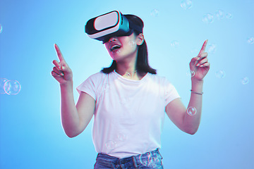 Image showing Woman, virtual reality and glasses for futuristic gaming, metaverse and user experience with high technology. Happy person press bubbles in VR fantasy, 3d vision and scifi on blue, studio background