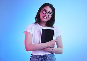 Image showing Young woman, student and tablet mockup for online education, e learning or study on blue, studio background. Asian person with digital technology, marketing space and university information on screen