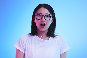 Image showing Surprise, portrait and face of Asian woman with wow expression or open mouth for drama, deal and promotion. Omg, wtf and portrait of person with discount emoji isolated in a studio blue background