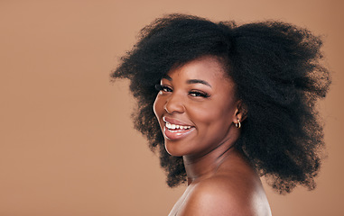 Image showing Portrait, hair care and black woman with beauty, cosmetics and shine on brown studio background. Mockup space, person or African model with texture, afro or makeup with aesthetic, natural or wellness