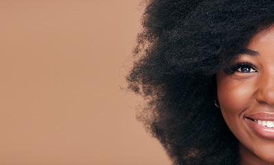 Image showing Portrait, hair and mockup with a model black woman in studio on a brown background for natural cosmetics. Half face, smile and haircare with a happy afro female person on space for shampoo treatment