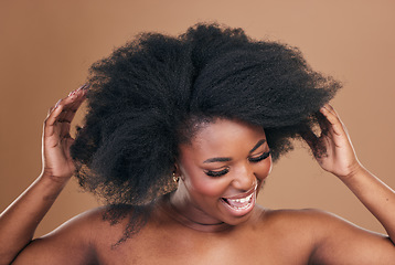 Image showing Beauty, hair and crazy with a model black woman in studio on a brown background for natural cosmetics. Face, smile and haircare with a playful young afro female person indoor for shampoo treatment