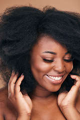 Image showing Smile, black woman and natural hair care for afro, beauty and wellness on a brown studio background. Growth, hairstyle or African model with cosmetics, aesthetic or shine with salon treatment or glow