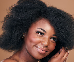 Image showing Face, beauty and hair with a model black woman in studio on a brown background for natural cosmetics. Afro, makeup and smile with a happy young female person indoor for organic haircare treatment