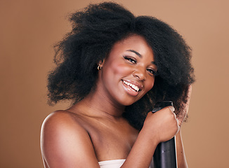 Image showing Portrait, hair and spray with a model black woman in studio on a brown background for natural cosmetics. Face, keratin and haircare with a happy young afro female person indoor for shampoo treatment