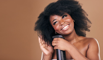 Image showing Thinking, hair and spray with a model black woman in studio on a brown background for natural cosmetics. Face, smile and haircare with a happy afro female person indoor for dry shampoo treatment