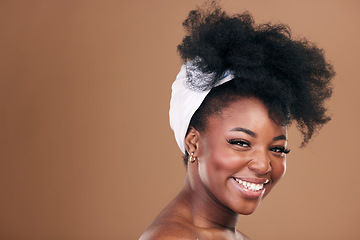 Image showing Beauty, hair and face with a model black woman in studio on a brown background for natural cosmetics. Smile, skincare and haircare with a happy young afro female person indoor for shampoo treatment