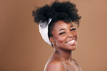 Image showing Portrait, hair care or happy black woman with afro, self love or smile on a brown studio background. Hairstyle, beauty or African model with texture, shine and volume with aesthetic, wellness or glow