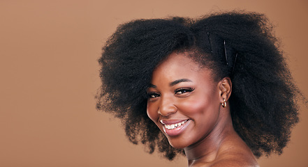 Image showing Portrait, hair care and black woman with natural beauty, shine and smile on a brown studio background. Mockup space, person and model with texture, afro and volume with aesthetic, wellness and glow