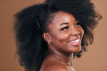 Image showing Hair care, afro or face of happy black woman with self love, shine or smile on a brown studio background. Hairstyle, healthy growth or African model with glow, beauty or wellness thinking of skincare