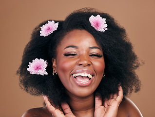 Image showing Portrait, hair care or happy black woman with flowers, afro or smile on a brown studio background. Hairstyle, beauty and African model with texture, shine and volume with aesthetic, wellness and glow