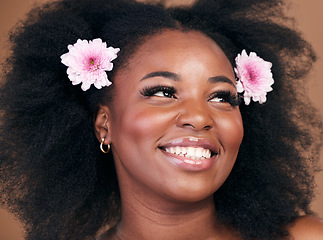 Image showing Hair care, flowers and black woman in afro, thinking and beauty in studio isolated on brown background. Smile, floral hairstyle cosmetic and natural African model in organic salon skincare treatment