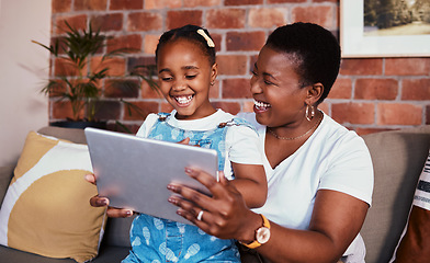 Image showing Happy, African mom and girl on tablet in home, living room and lounge with online education, games and learning technology. Streaming, mobile app or mother and child relax with social media on sofa