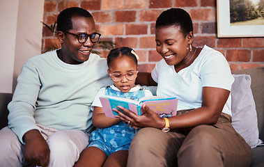 Image showing Family, happy and reading a book on a home sofa with glasses for learning, knowledge and time together. A man, woman and girl kid in a lounge with love, care and happiness with a story in house