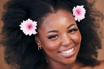 Image showing Face, flowers and black woman in afro hair care, smile and beauty in studio isolated on a brown background. Portrait, floral hairstyle cosmetic and natural African model in organic salon treatment