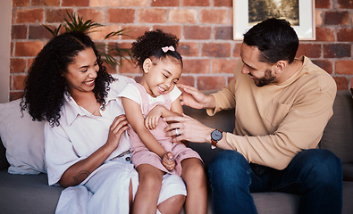 Image showing Family, tickle and laughing while playing on a home sofa for fun, bonding and time together. A happy man, woman or parents and girl kid in lounge with love, care and happiness in house in Puerto Rico