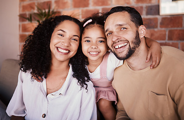 Image showing Family, happy and portrait with a hug on a home sofa for fun, bonding and time together. A man, woman or parents and girl kid in a lounge with love, care and happiness in a house in Puerto Rico