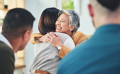 Image showing Business people, women and hug in group therapy in office, care or bonding for mental health with smile. Corporate men, staff and colleagues with embrace for team building, welcome and happy together