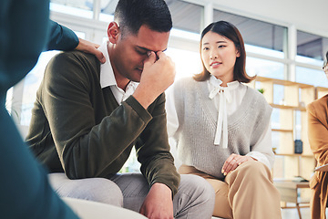 Image showing Group, support and psychologist comfort man in depression, anxiety or trauma stress in meeting. Counseling, therapy and people, community help or empathy, hope or care in mental health rehabilitation