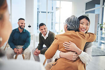 Image showing Business people, women and hug in group therapy with care, love and bonding for mental health in workplace. Corporate men, staff and colleagues with smile for team building, diversity and gratitude