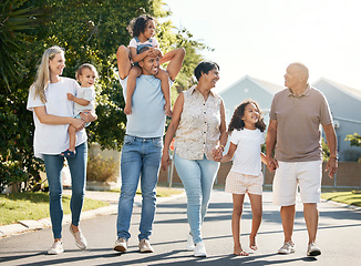 Image showing Happy, big family and walking outdoor in neighbourhood street together for fun, bonding or activity with kids, parents and grandparents. Summer, vacation or grandchildren on holiday or adventure