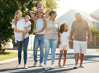 Image showing Big family, outdoor and walking in neighbourhood together for fun, bonding or activity with kids, parents and grandparents. Summer, time and happy people relax with children on vacation or holiday