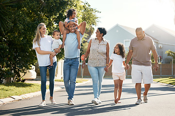 Image showing Outdoor, big family and walking in neighbourhood street together for fun, bonding or activity with kids, parents and grandparents. Happy, time and relax in urban summer with children on vacation