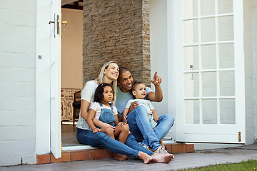 Image showing Parents, children and sitting on steps, outdoor and pointing with view, thinking and relax in backyard at family home. Interracial couple, young kids and happy together on patio, veranda and garden