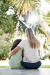 Image showing Child, adoption and together with mom for hug, support or love in backyard, garden or family home of girl in foster care. Interracial, mother and daughter bonding in embrace or sitting outdoor