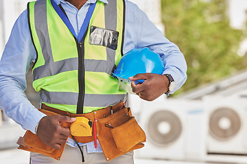 Image showing Man, helmet closeup or engineer on construction site for maintenance or architecture outdoor. Body of contractor, professional renovation or handyman building urban infrastructure with tools on waist