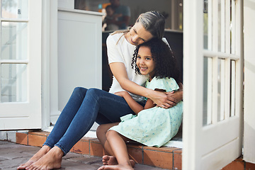 Image showing Adoption, mom and child together for hug, support or love in family home of girl in foster care with a smile of happiness. Interracial, mother and daughter bonding in embrace or playing outdoor