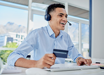 Image showing Credit card, online shopping and call center man in the office for sale, promotion or discount. Ecommerce, technology and male telemarketing agent paying bills, mortgage or debt online in workplace.