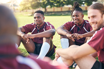 Image showing Sports, rugby and men on grass for rest at training, practice and exercise workout for match. Fitness, teamwork and male people relax for planning strategy for competition, challenge or game on field