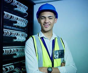 Image showing Engineering, portrait and man with smile in server room for network maintenance, software upgrade and programming cables. IT technician, electrician or arms crossed in data center for database backup