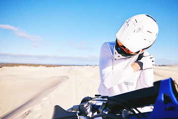 Image showing Stretching, shoulder pain and person on motorbike with a strain or injury in desert ready for extreme sports. Performance, training and hurt rider in nature for exercise with motorcycle on dirt road