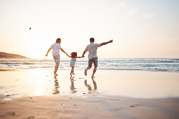 Image showing Gay couple on beach, men and child, playing together and holding hands at sunset, running in waves on holiday. Love, happiness and sun, lgbt family on tropical ocean vacation and fun with daughter.