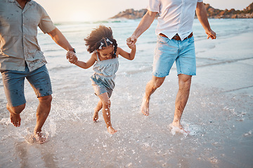 Image showing Beach, running and parents holding hands with girl in water on holiday, vacation and adventure. Lgbtq family, summer and happy child with fathers by ocean for bonding, relationship and fun outdoors