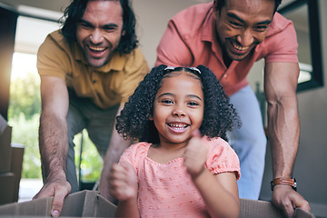 Image showing Family home, girl and box with parents, push and gay dad with games, portrait and playing on floor with moving. LGBTQ men, female kid and cardboard package for car, airplane and driving in new house