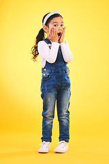 Image showing Children, fashion and hands on face of girl child in studio with deal, sale or giveaway promo on yellow background. Wow, surprise and open mouth kid with emoji for news, announcement or sign up info