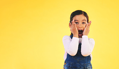 Image showing Portrait, fashion and hands on face of girl child in studio with deal, sale or giveaway promo on yellow background. Excited, surprise and open mouth kid with emoji for news, announcement or wow info