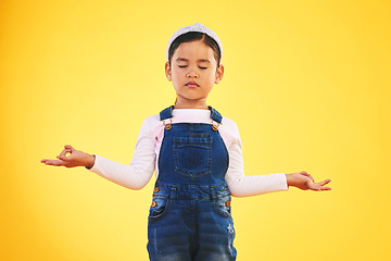 Image showing Lotus, hands and girl child with meditation in studio for wellness, peace or balance on yellow background. Children, mental health and kid with yoga pose for energy training or holistic exercise