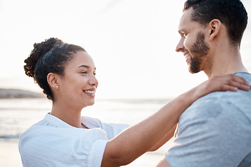 Image showing Couple, hug or bonding on beach at sunset for Portugal summer holiday, vacation or travel break by nature ocean. Smile, support or love trust for relax man and happy woman by sea for romantic sunrise