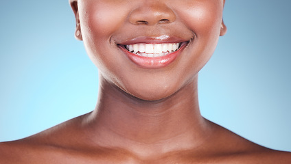 Image showing Woman, teeth and smile in dental care, hygiene or treatment against a blue studio background. Closeup of female person mouth in tooth whitening, oral or gum healthcare or cleaning in healthy wellness